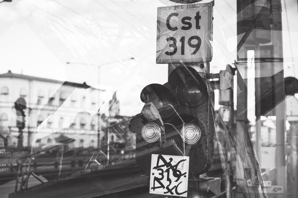 Free Image of Black and white traffic signal with building in background 
