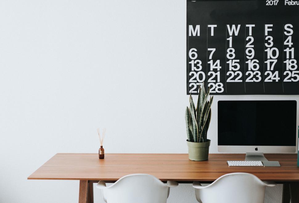 Free Image of Minimalist office desk with a computer and calendar 