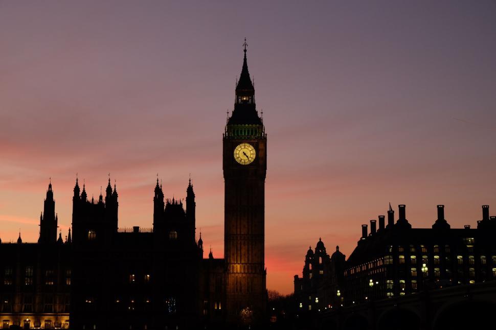 Free Image of London s Big Ben at sunset with surrounding buildings 