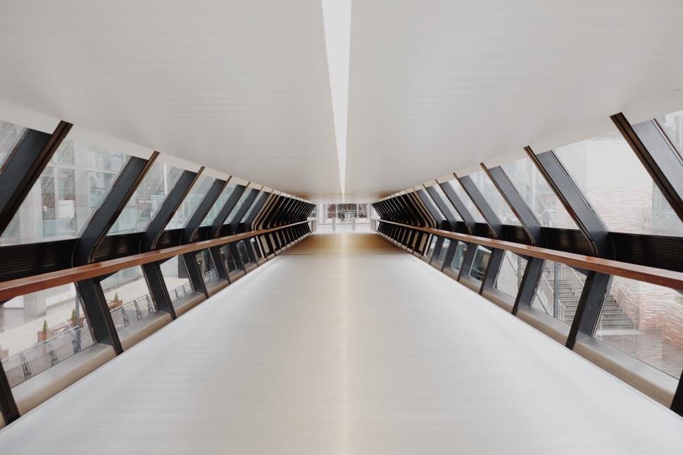 Free Image of Modern architectural hallway with extensive glass panels. 