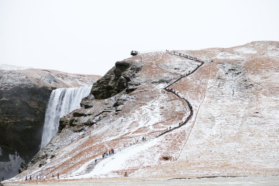 Free Image of Winding path with stairs leading up snowy mountain. 