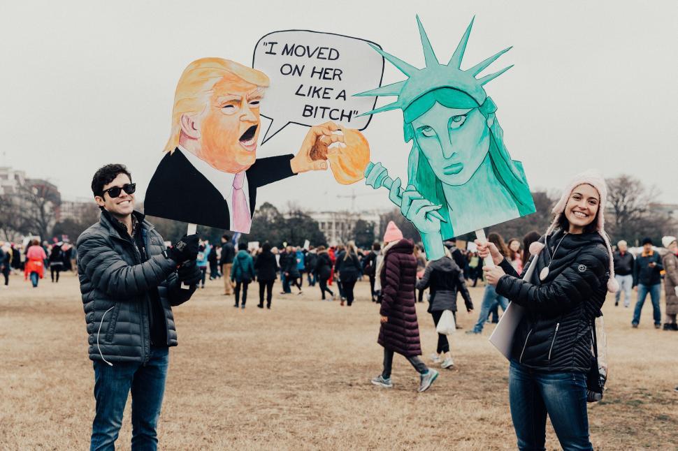 Free Image of People holding satirical signs at a protest event. 