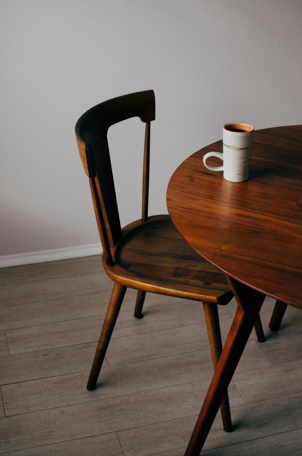 Free Image of Minimalist wooden table with wooden chair and coffee mug 