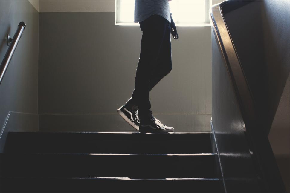 Free Image of Silhouette of person ascending stairs in natural light 