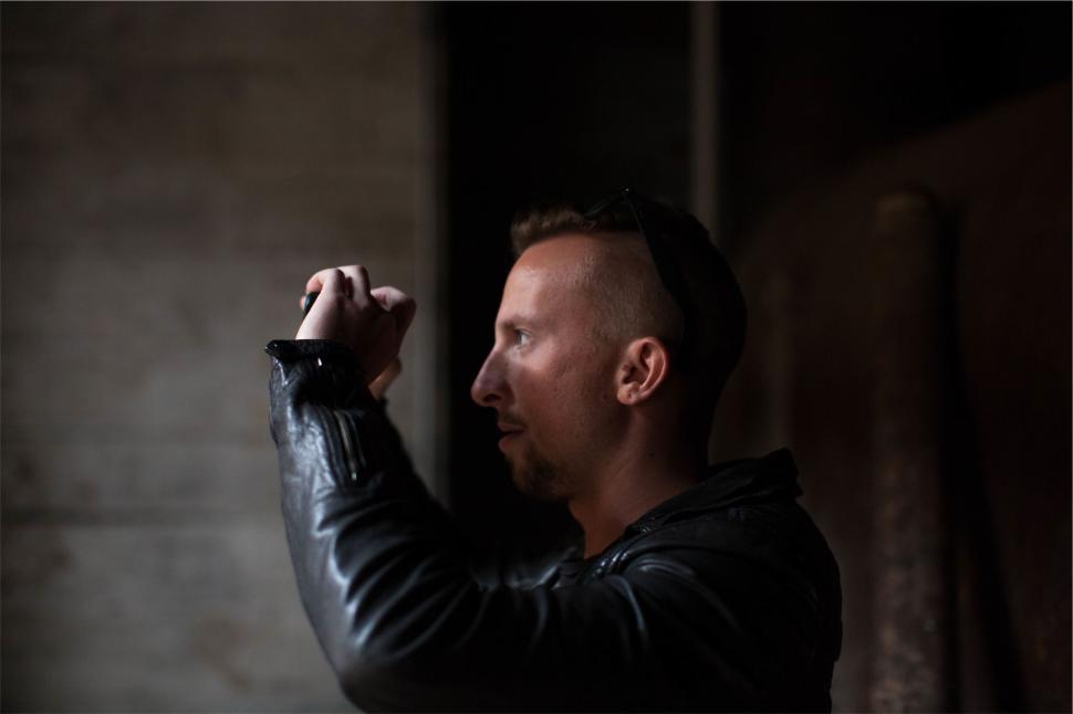 Free Image of A person taking a photograph with an old camera indoors 