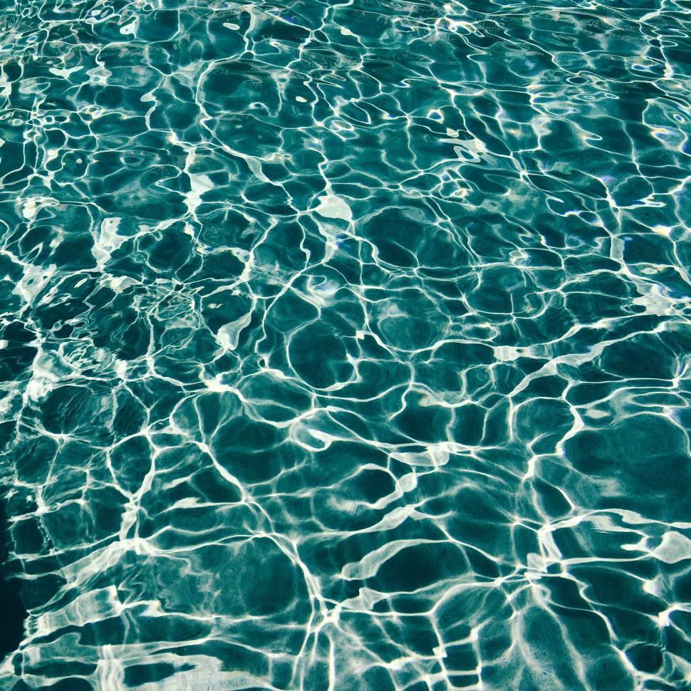Free Image of Vibrant and crystal-clear swimming pool water surface 