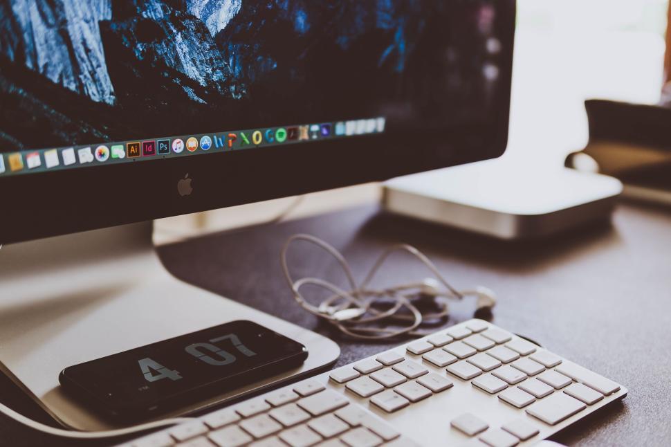 Free Image of Desktop computer setup with keyboard and smartphone 