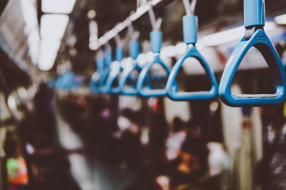 Free Image of Close-up view of blue subway handles in a subway car 