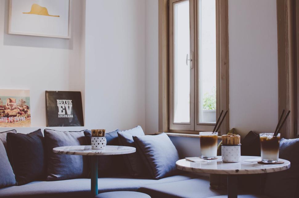 Free Image of Cozy cafe interior with two iced coffees on table. 