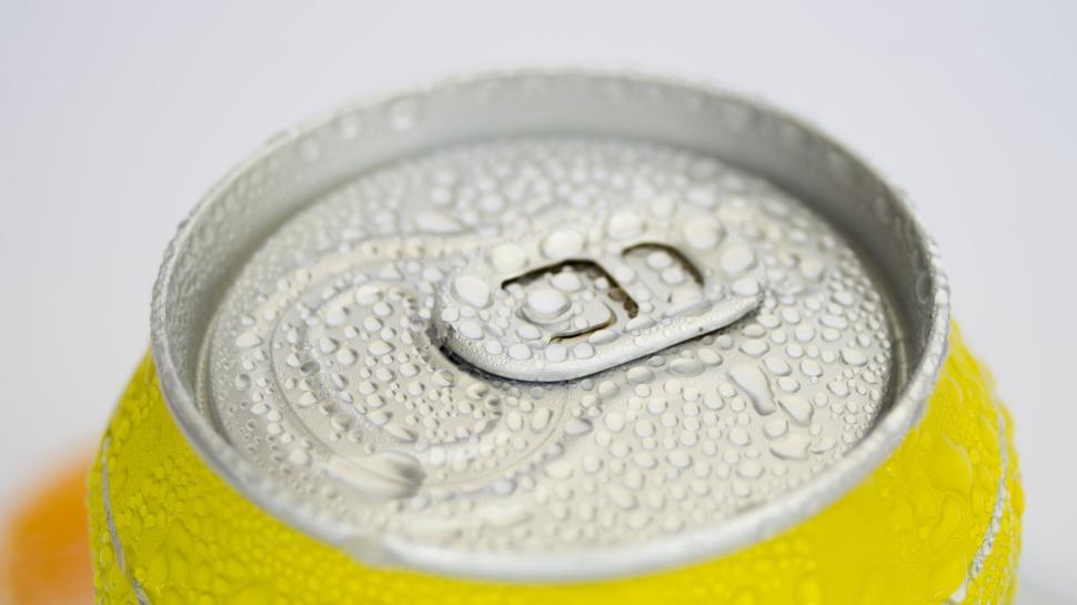 Free Image of Close-up of condensation on yellow metal soda can lid. 
