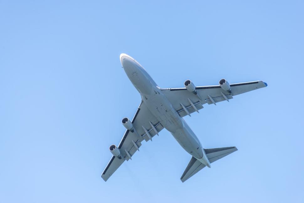 Free Image of Commercial airplane soaring high in the bright sky. 