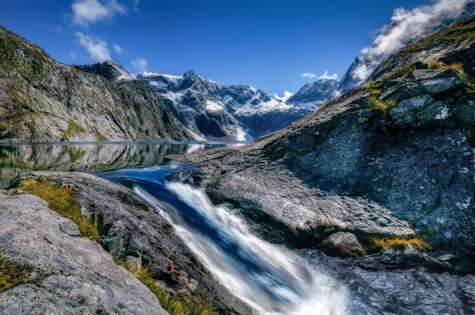 Free Image of Mountain stream flowing through rugged rocky terrain 