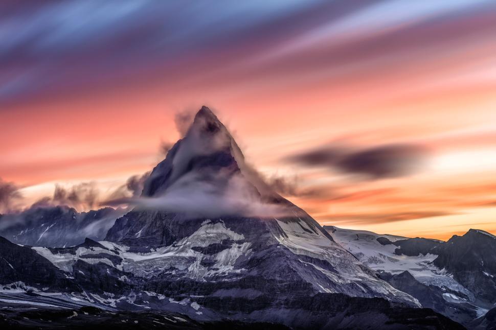 Free Image of Majestic mountain peak engulfed in vibrant sunset 