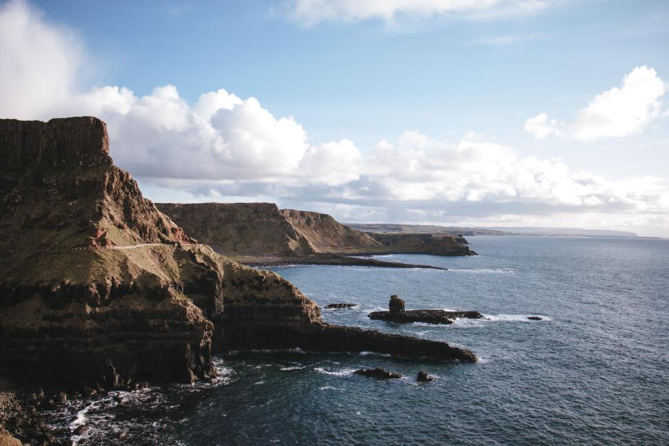 Free Image of Rugged coastline with rocky cliffs and clear waters 