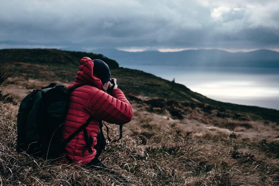 Free Image of Photographer capturing a scenic view of a landscape 