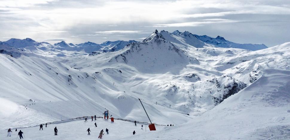 Free Image of Skiers on snow-covered slope on a sunny winter day. 