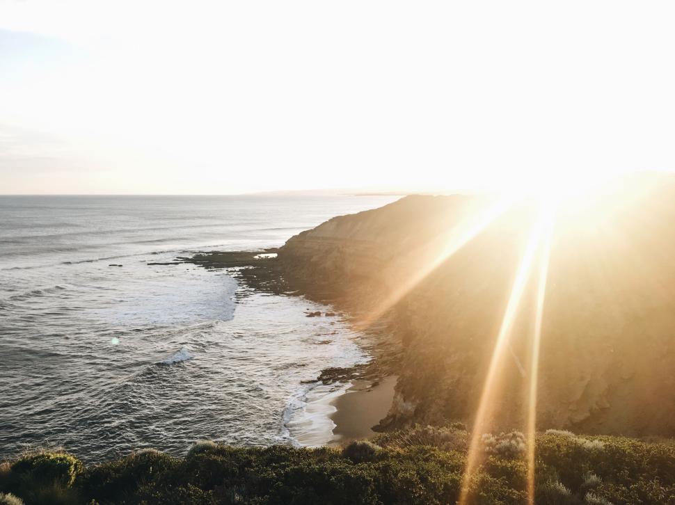 Free Image of Golden sunset over coastal cliffs and wide ocean view 