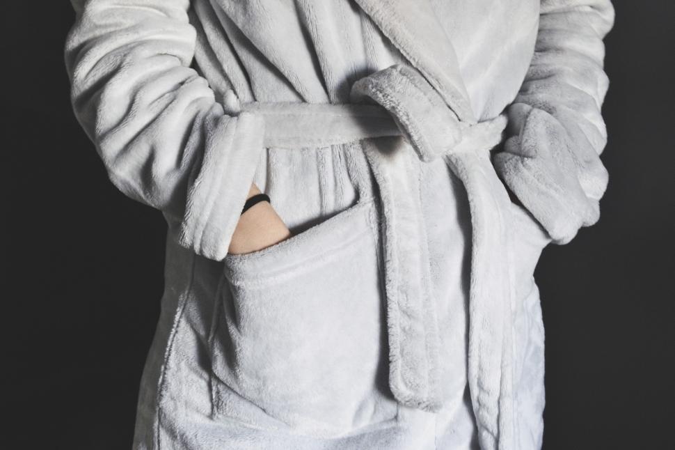 Free Image of Person in a fluffy gray bathrobe with hands in pockets 