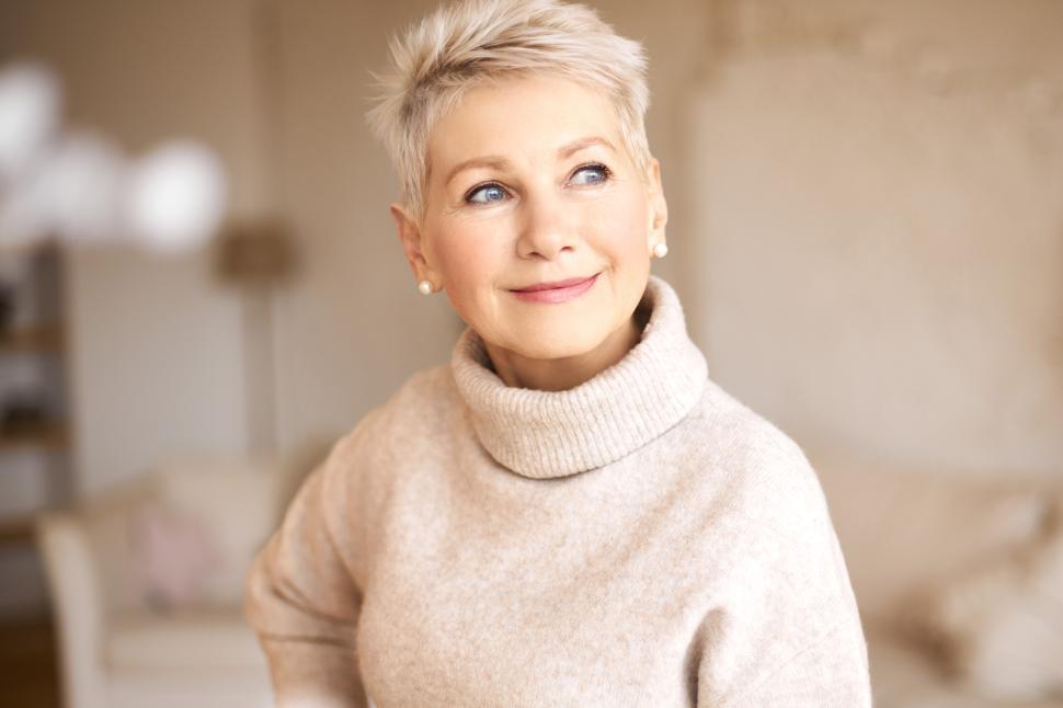 Free Image of People, age and maturity. Close up shot of elegant blonde middle aged woman with short haircut looking up with pensive smile, thinking about something pleasant, making plans, recollecting old days 