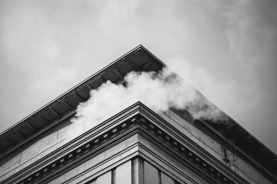 Free Image of Building corner with steam rising from the rooftop. 