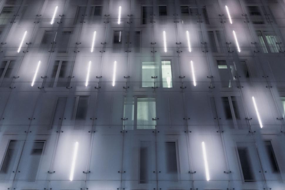 Free Image of Modern building facade with illuminated horizontal lights. 