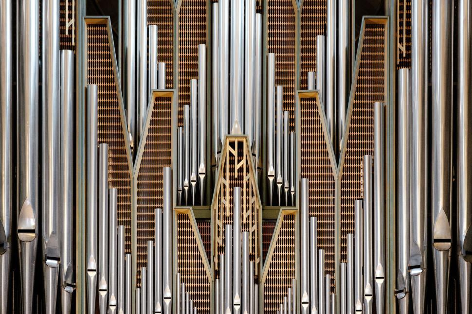 Free Image of Symmetrical pipe organ with golden decorative elements 