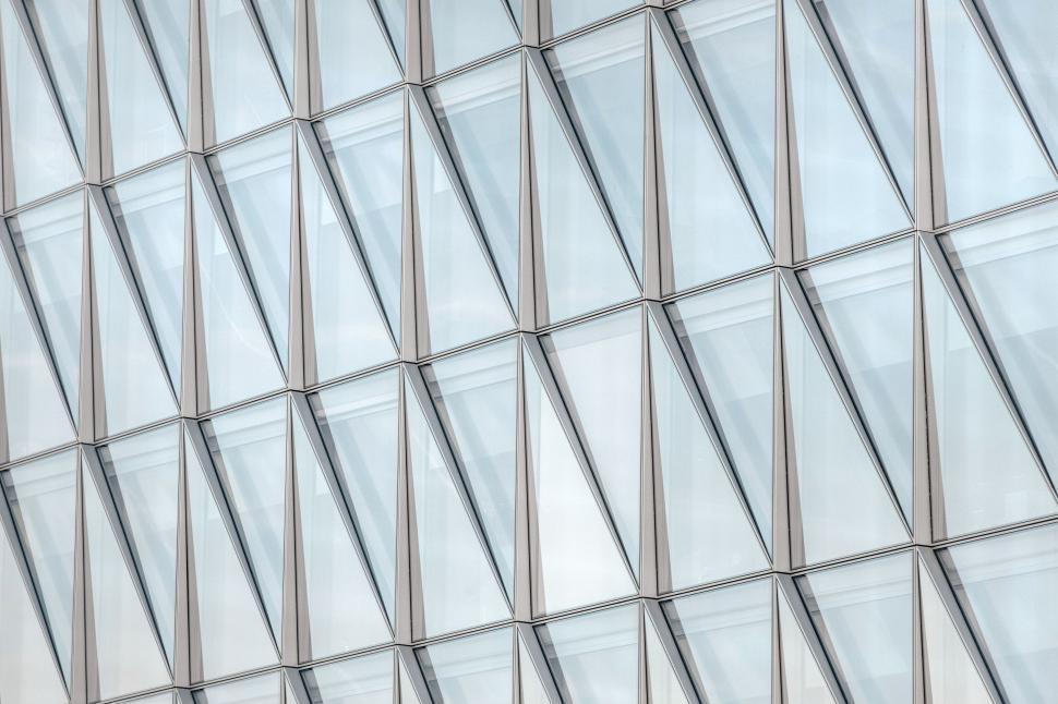 Free Image of Geometric glass facade with mirrored reflections pattern 