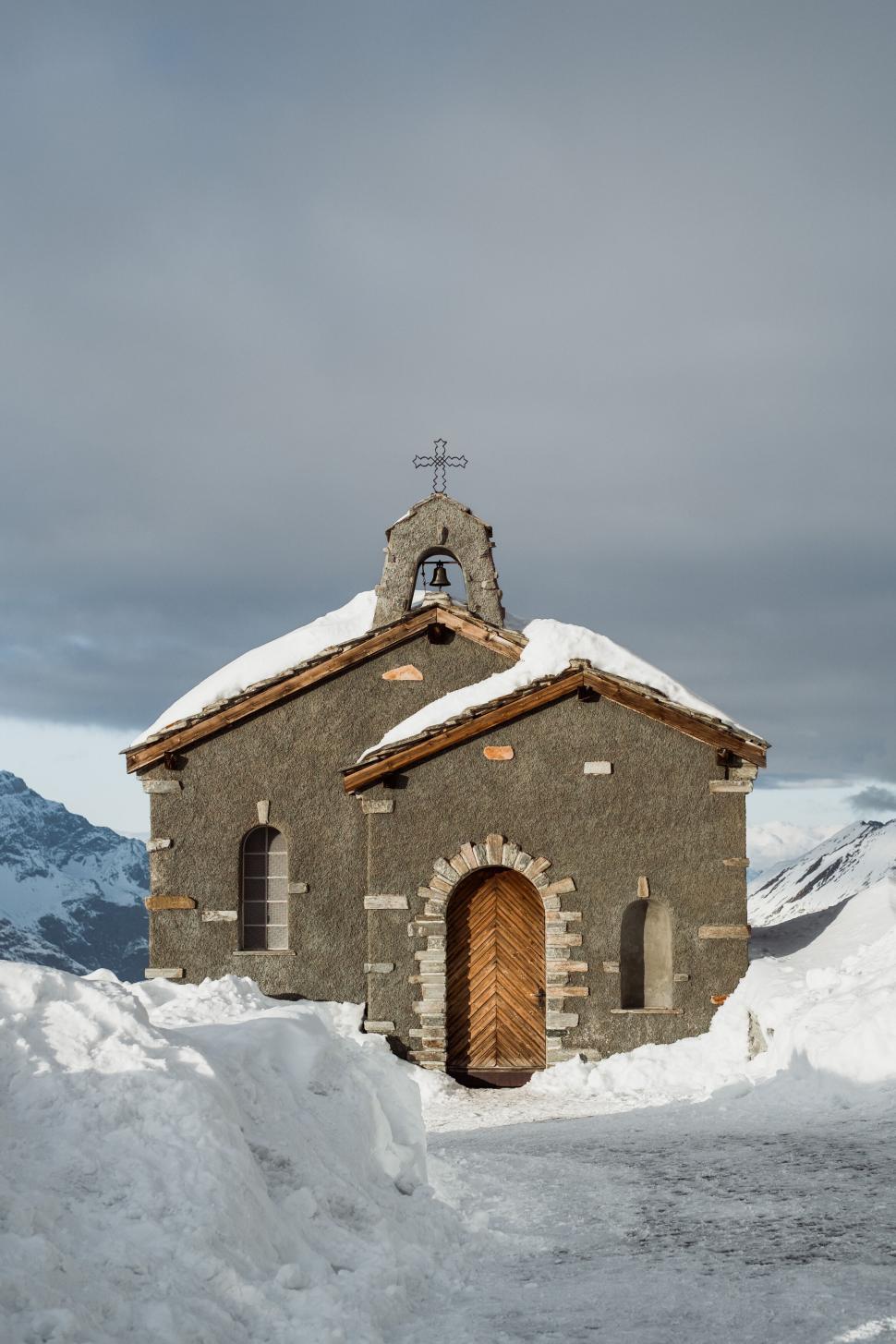 Free Image of Snow-covered small stone chapel in mountainous landscape 
