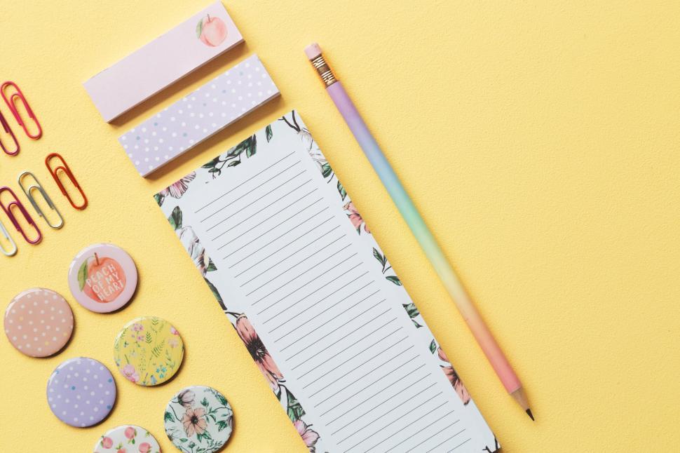 Free Image of Colorful stationery items arranged on a yellow surface. 