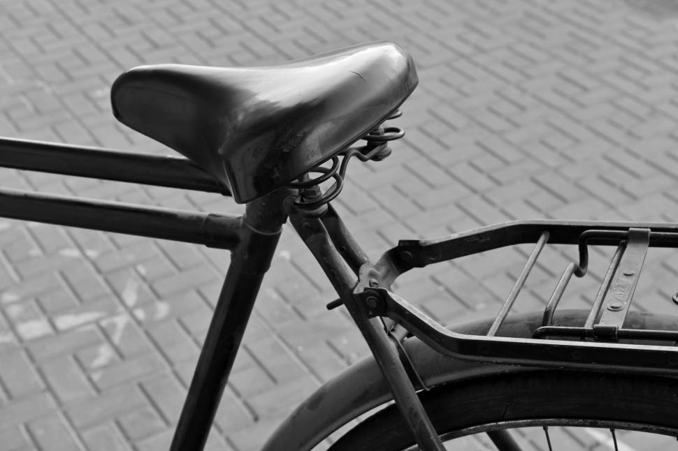 Free Image of Black and white image of a vintage bicycle seat close-up 