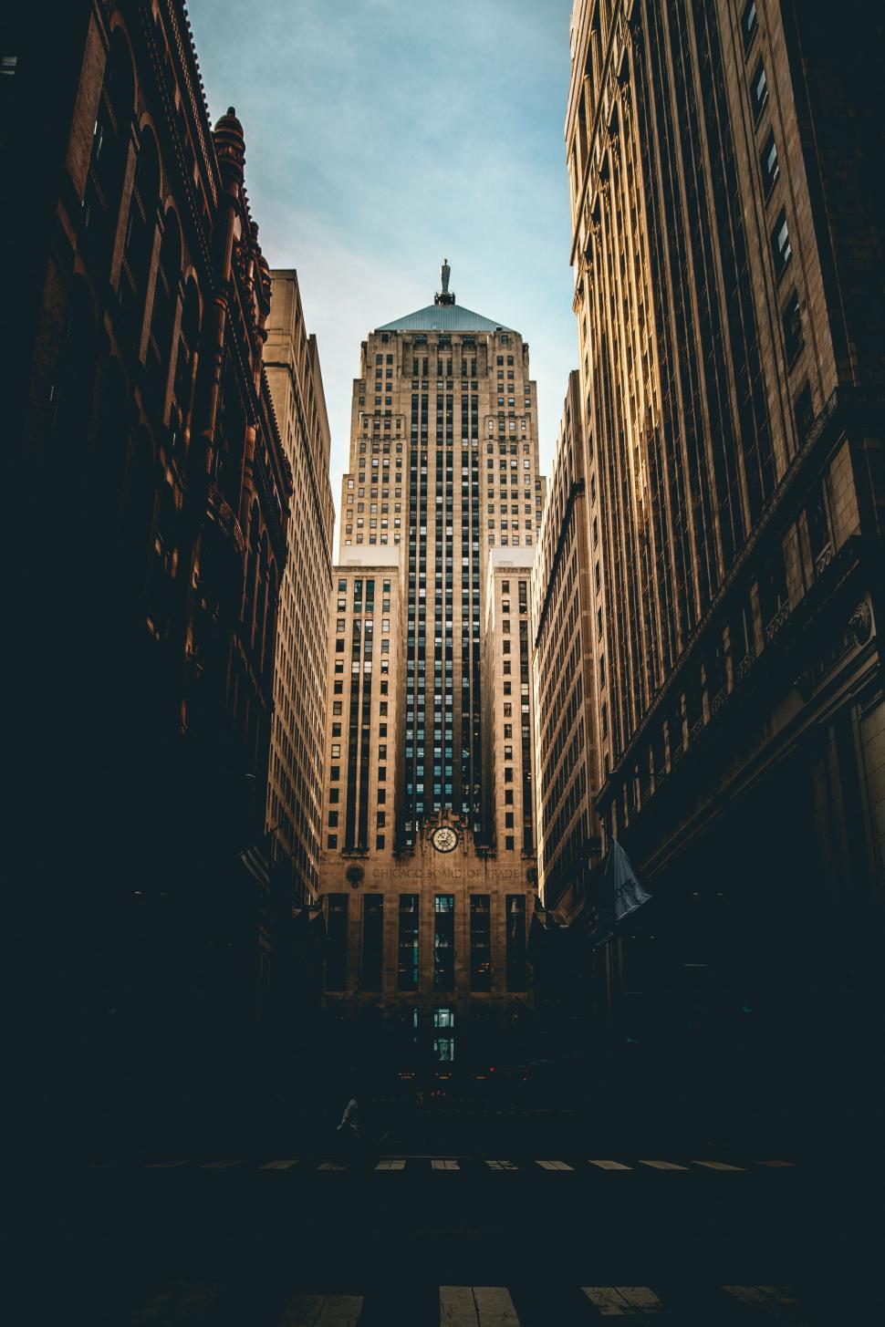 Free Image of Tall skyscraper surrounded by shadows from nearby buildings 
