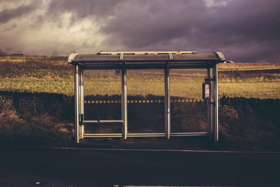 Free Image of Empty bus stop shelter against a dramatic cloudy sky. 