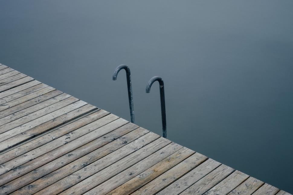 Free Image of Empty Dock with a Ladder Descending into Still Waters 