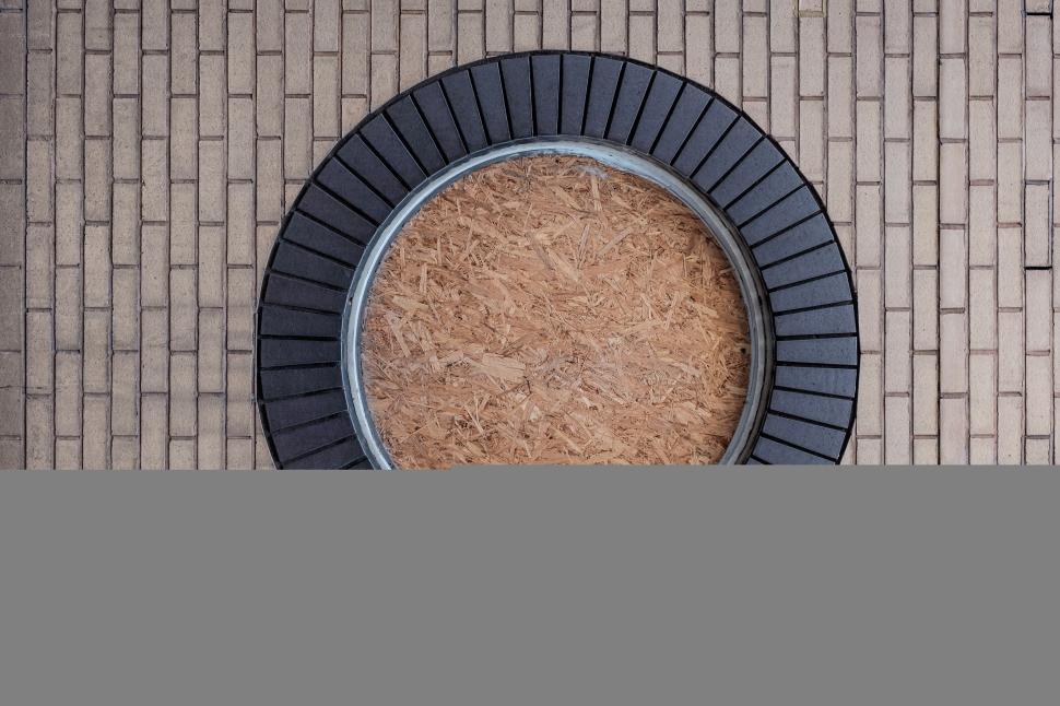 Free Image of Circular architectural element surrounded by brick pattern 