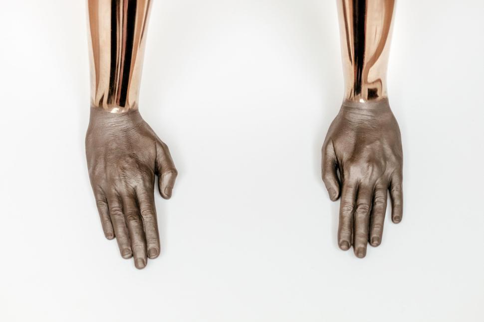 Free Image of Metallic sculpted hands on a white background minimal art 