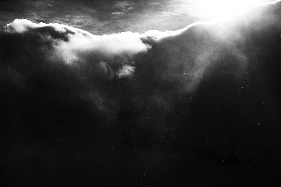 Free Image of Ethereal clouded sky with sunlight breaking through. 