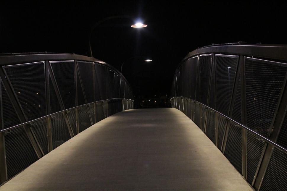 Free Image of Illuminated pedestrian bridge captured in night time view. 