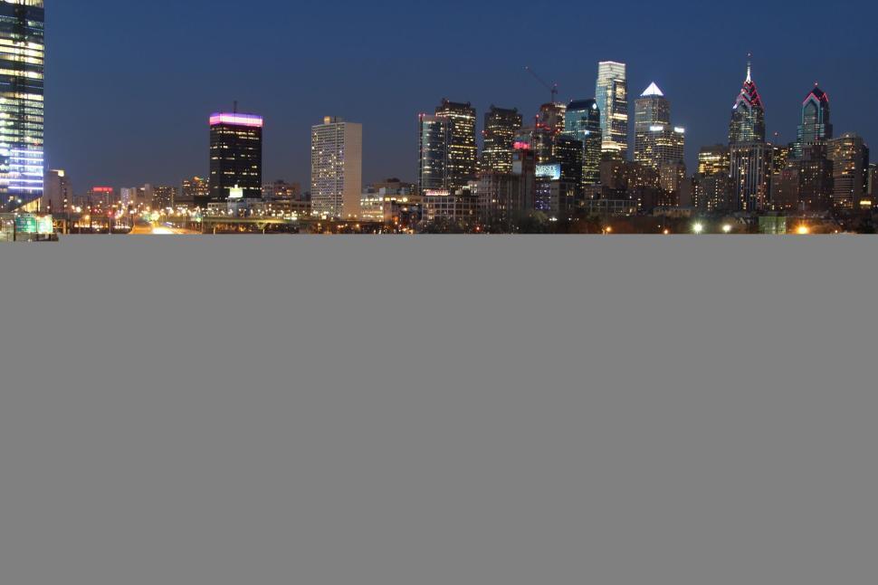 Free Image of Nighttime cityscape with river and illuminated walkway. 