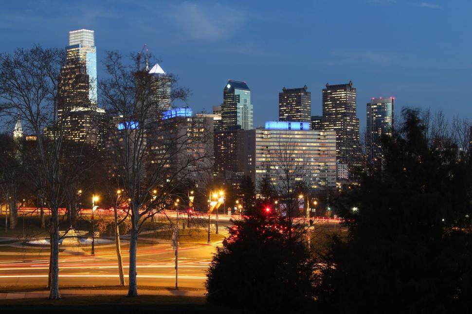 Free Image of City skyline at dusk with lights and towering buildings. 