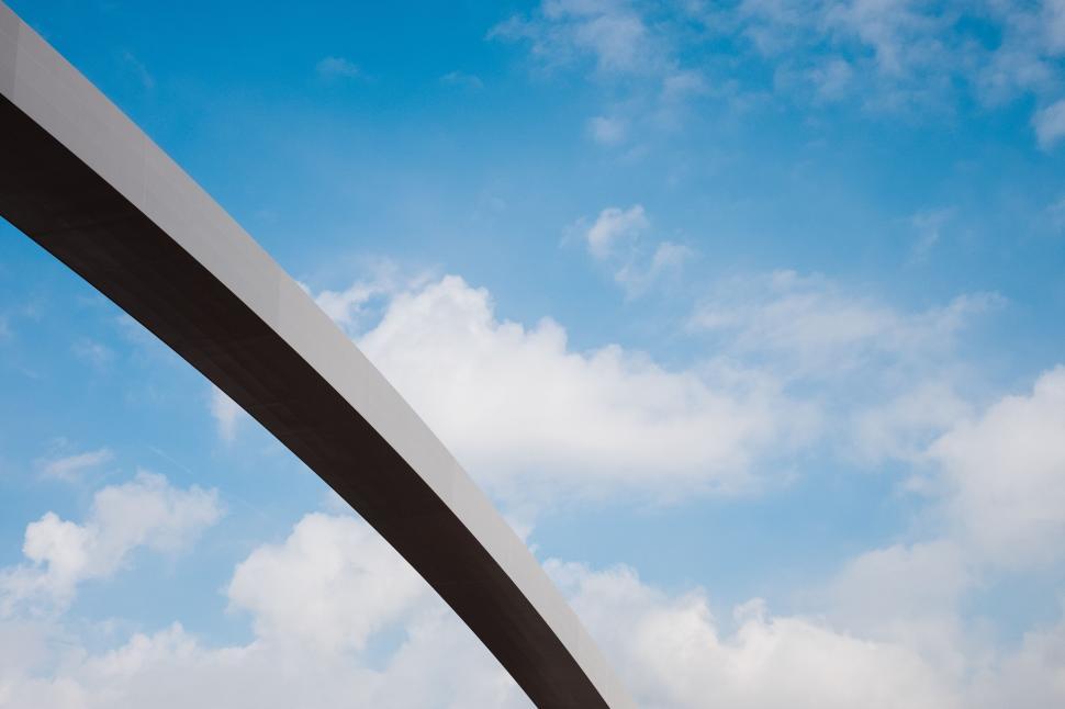 Free Image of Modern bridge arch against a bright blue sky 