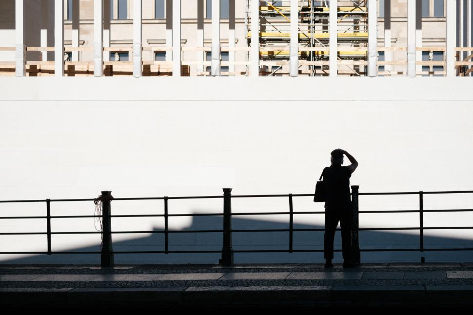 Free Image of Silhouette of person photographing construction site 