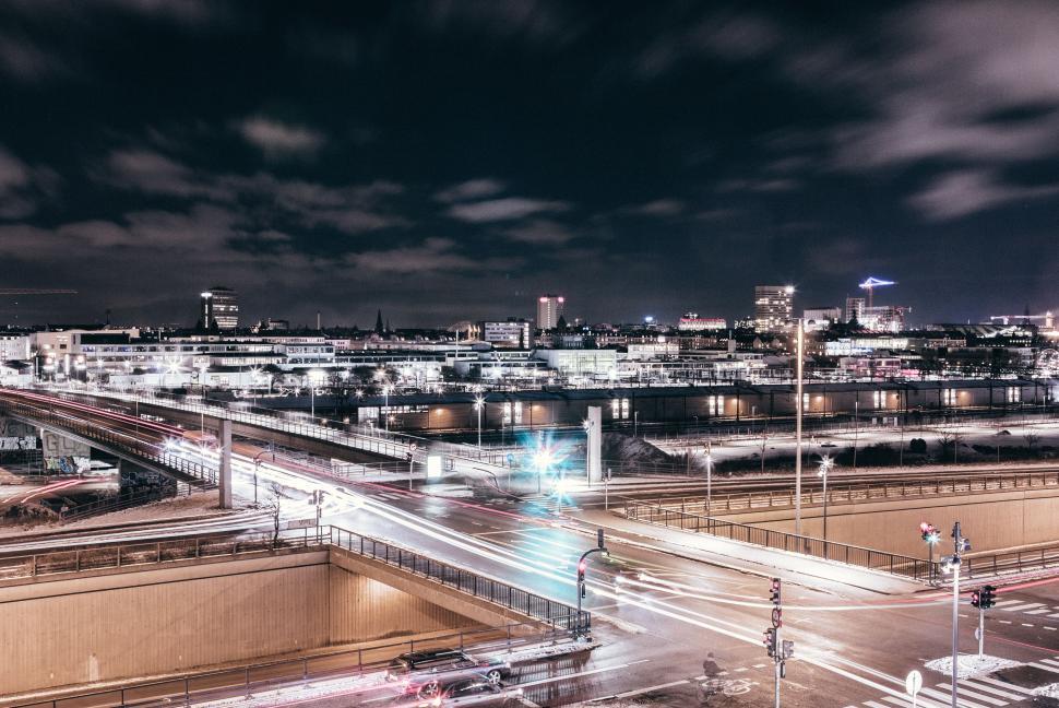 Free Image of Nighttime cityscape with bright lights and overpass view 