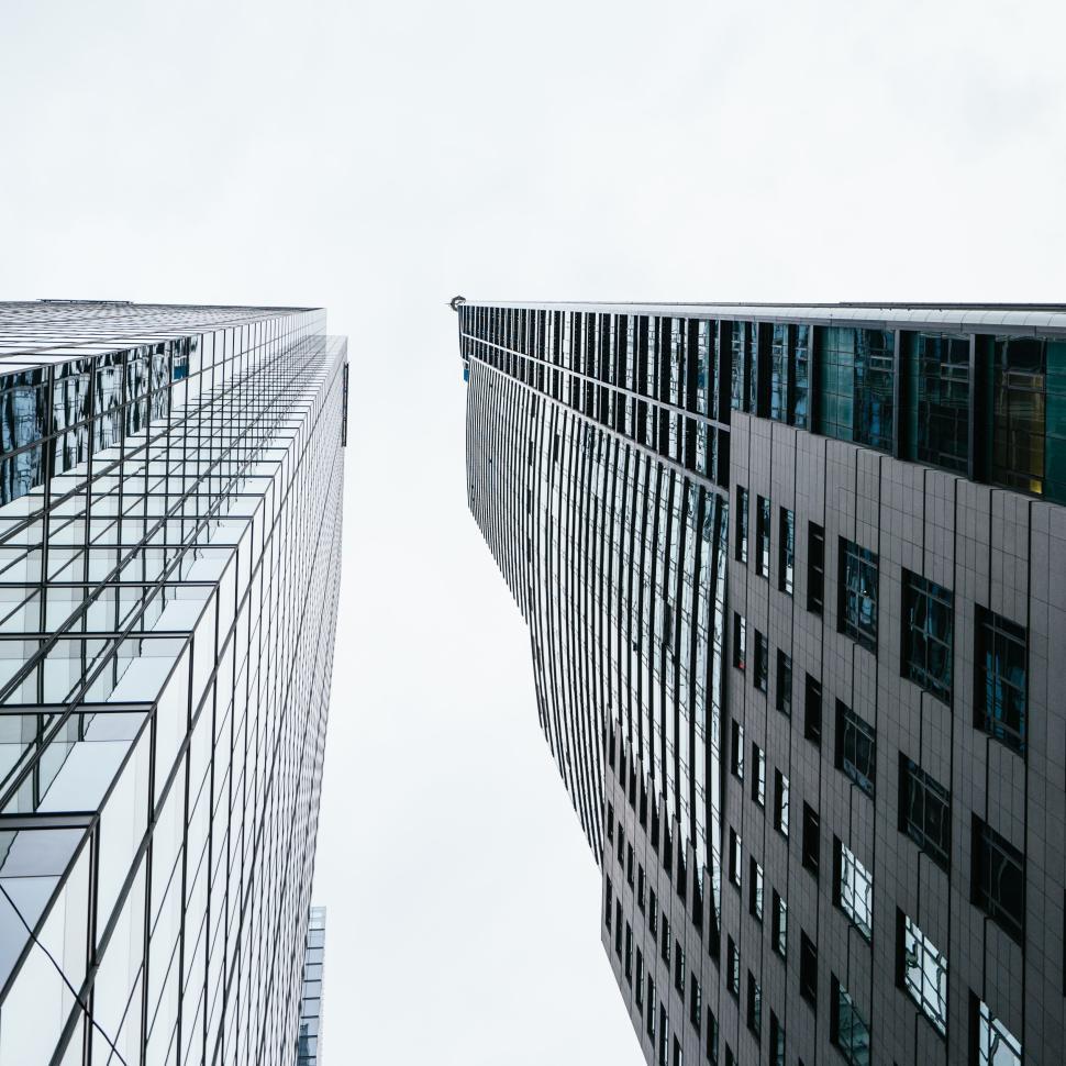 Free Image of Looking up between modern skyscrapers with glass facade 