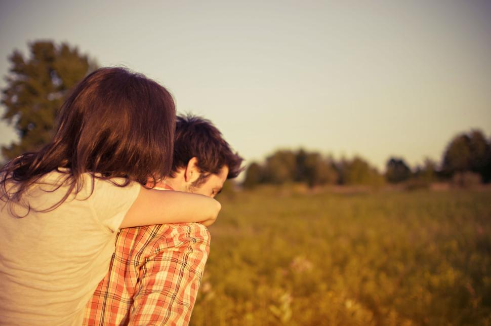 Free Image of Person giving piggyback ride in an open field 