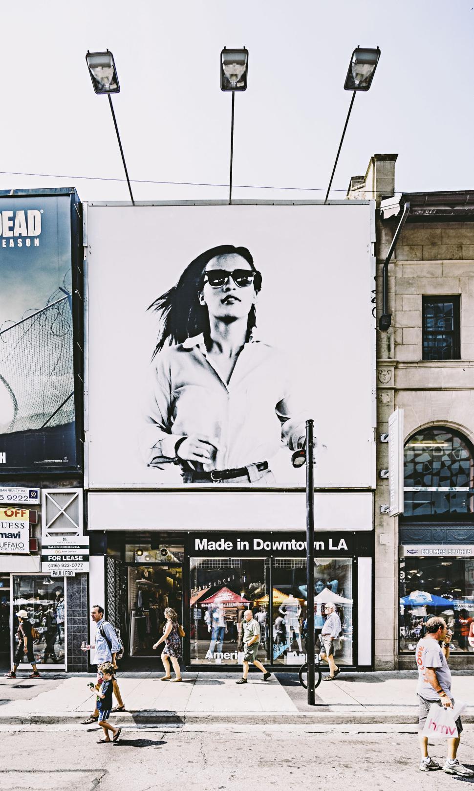 Free Image of Large black and white poster of woman on urban street wall 