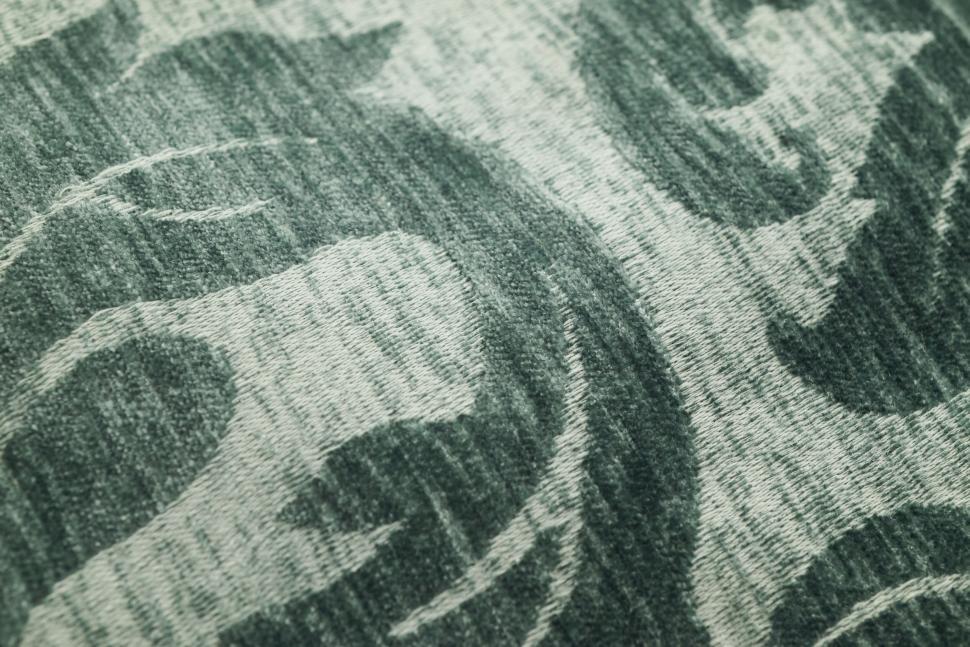 Free Image of Close-up of green and white fabric with swirling pattern. 