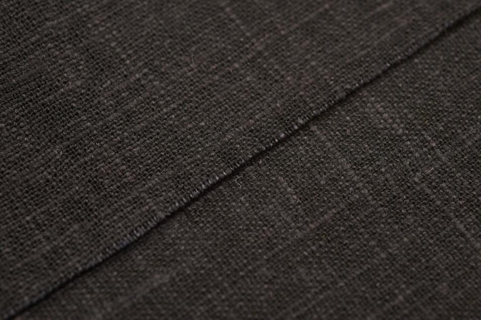 Free Image of Close-up of a dark textured fabric with fine details 