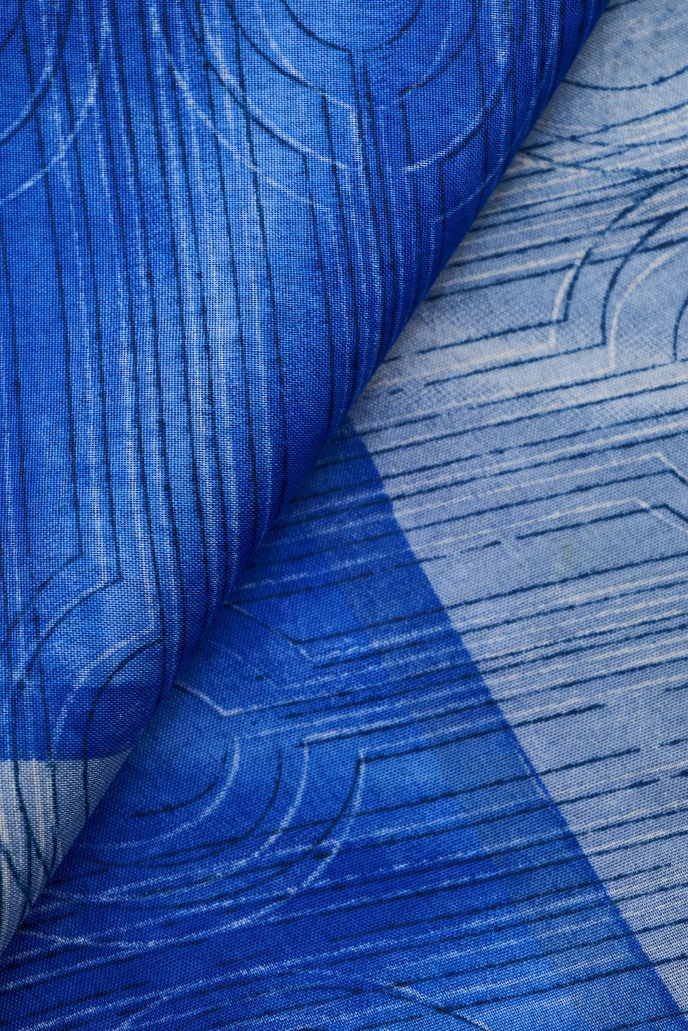 Free Image of Blue geometric pattern textile folded in a closeup. 