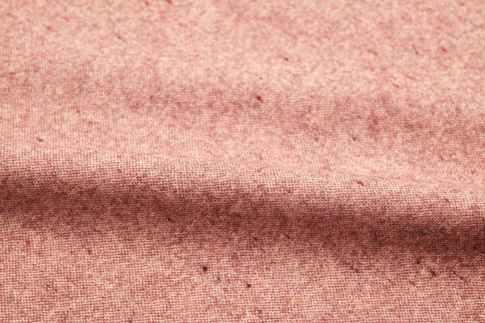 Free Image of Texture of light pink fabric with tiny flecks of color. 