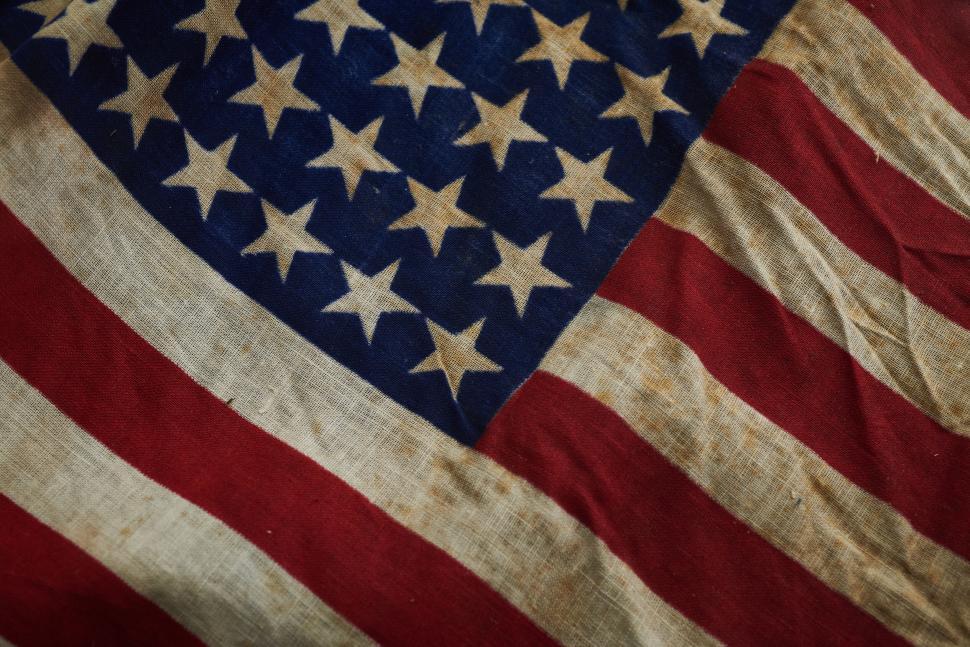 Free Image of Vintage and weathered American flag showing patriotic pride. 